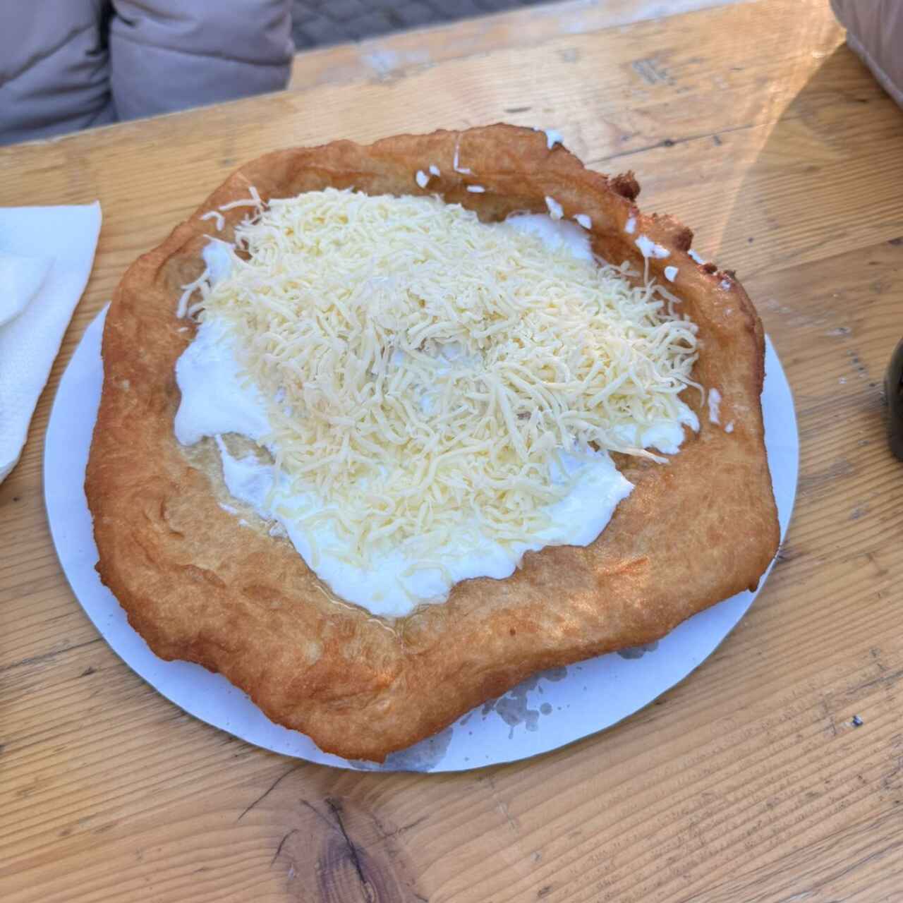 Traditional Hungarian lángos with sour cream and cheese served at Budapest Christmas market