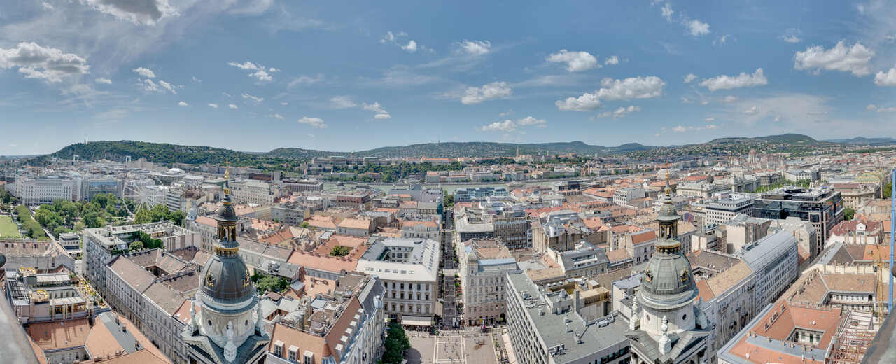 Panoramic view of Budapest from the tower of St Stephen’s Basilica, with rooftops, hills and monuments visible in the distance