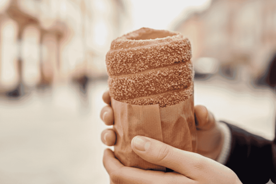 Hands holding a chimney cake, traditional hungarian food