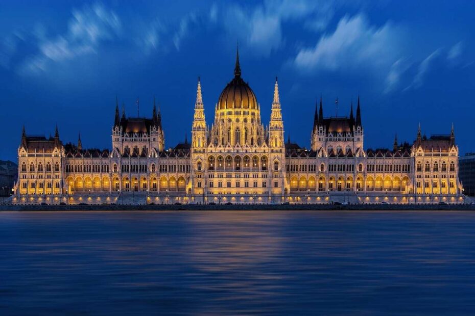 Hungarian Parliament Building illuminated at night as seen from the Danube River, a highlight of Budapest night river cruises.