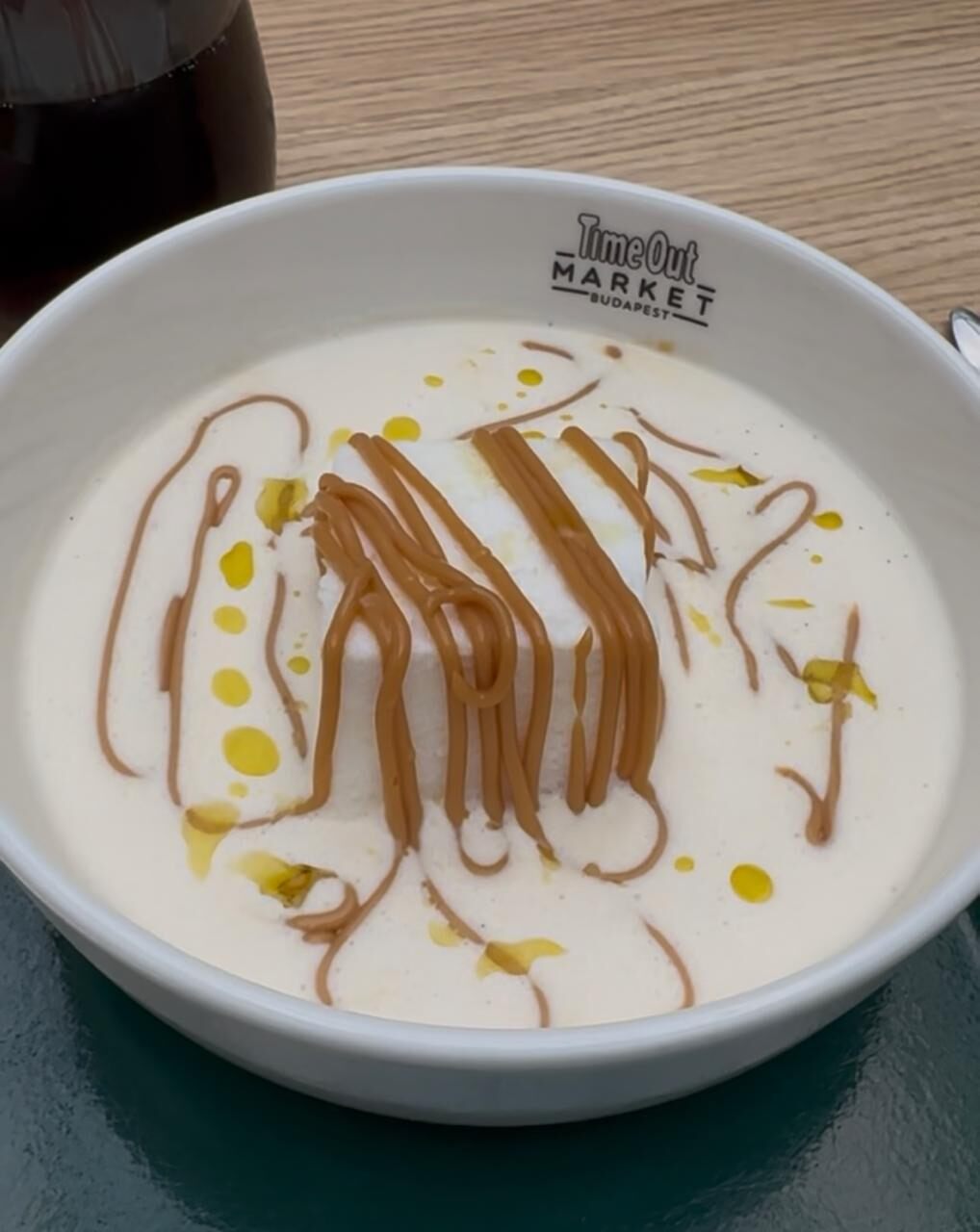 Hungarian madár tej dessert served in a bowl, with fluffy meringue floating on vanilla milk at Time Out Market Budapest