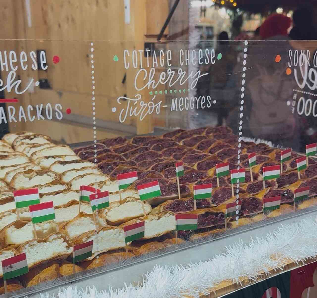 Hungarian rétes pastry filled with cottage cheese and cherry, displayed at a traditional market stall in Budapest